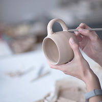 Female Potter Making Mug