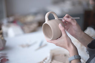 Female Potter Making Mug