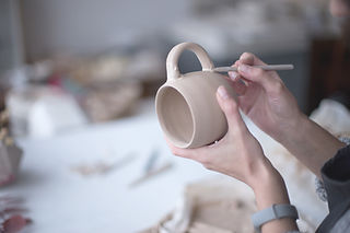 Female Potter Making Mug 