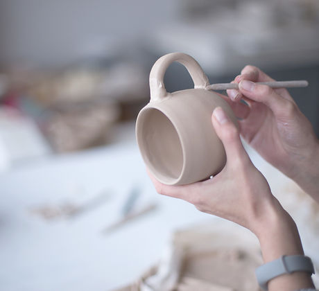 Female Potter Making Mug