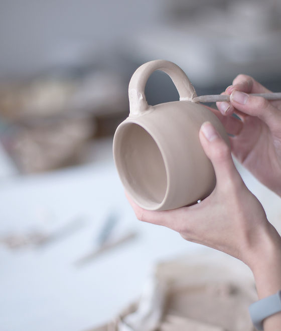 Female Potter Making Mug