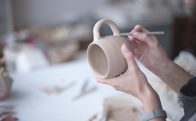 Female Potter Making Mug