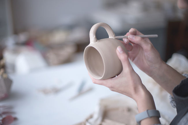 Female Potter Making Mug