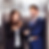 Professional man and woman inside an elevator where one is giving their elevator pitch