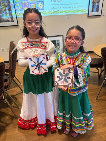 Young artists showing off their Talavera-inspired tiles made in the art class.