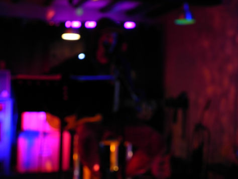 Abstract blurry concert background with purple and pink stage lights.