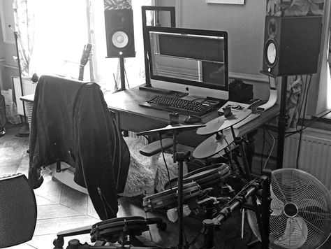 Audio production workstation with a microphone and electronic drums.