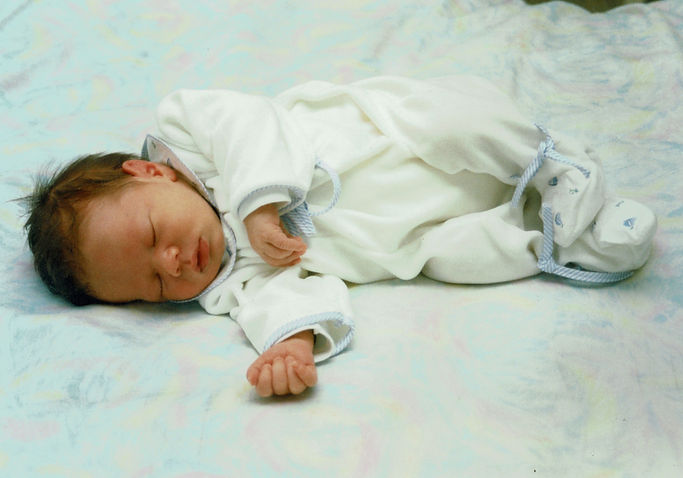 A2L, as a baby, sound asleep and all dressed up.