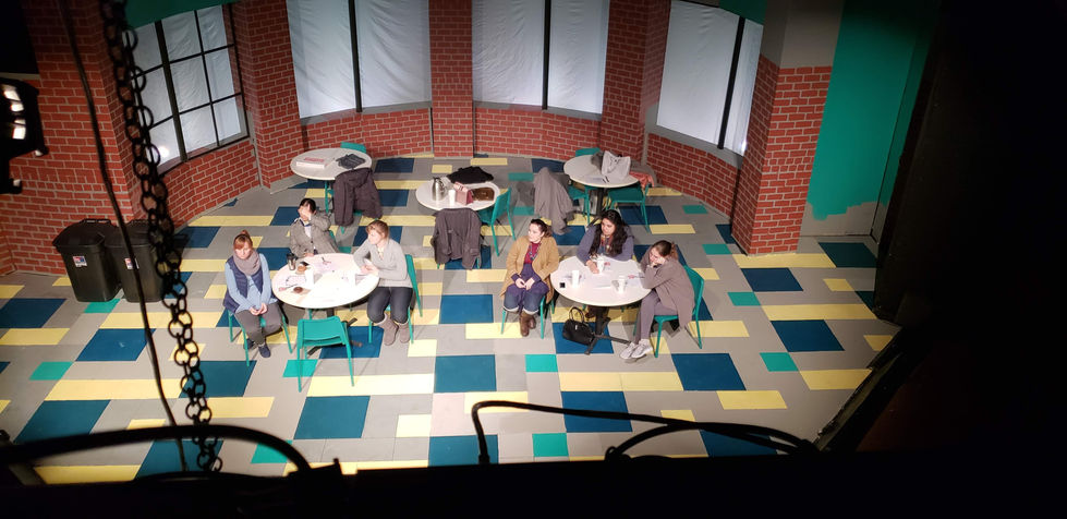 The completed Benefit Committee set with actors looks like the inside of a grade school with checkered floors