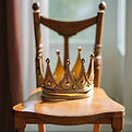 A simple crown placed on an empty chair.jpg