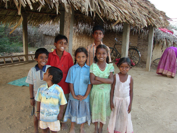 Seven smiling children pose for camera