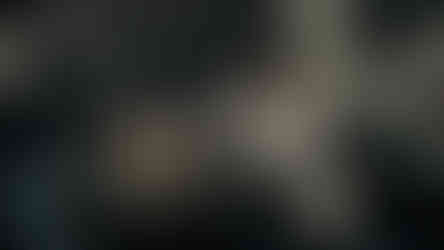 Tattoo artist creating a detailed design on a client’s skin