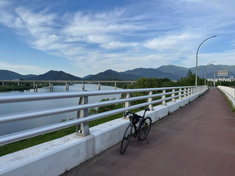 Serene morning bike ride along the river with mountain views.