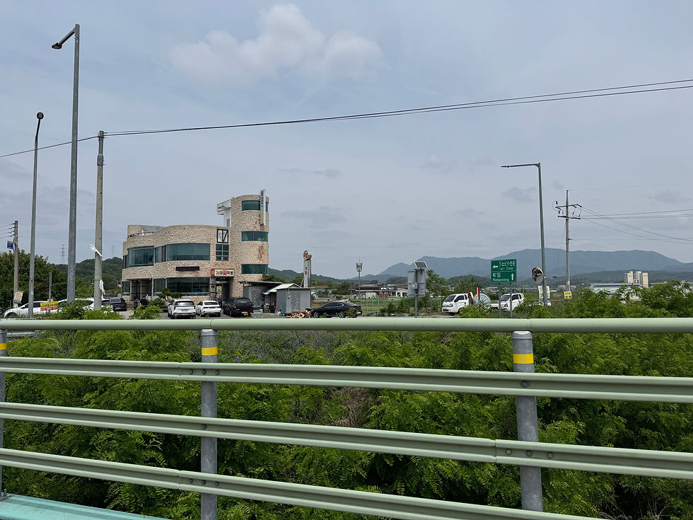 An old restaurant building, framed by distant mountains and a cloudy sky in Gyeongsangbuk-do, South Korea.