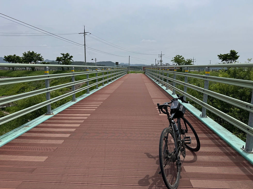 Bicycle resting on a quiet bridge under a clear sky.