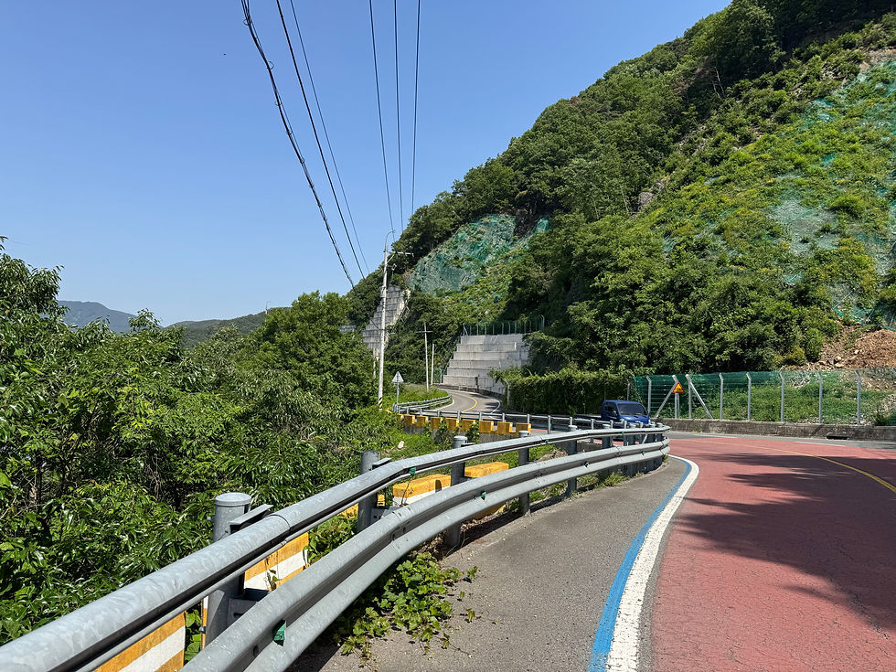 Winding mountain road under a clear blue sky.