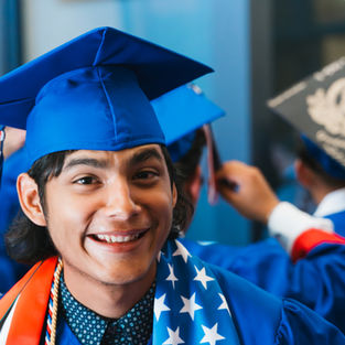 Smiling graduate in a blue cap