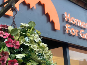 Hanging basket and the Homes for Good sign outside new Dumfries branch