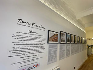 Introductory text and framed photos from the Stories From Home Exhibition