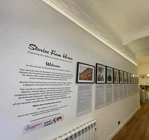 Introductory text and framed photos from the Stories From Home Exhibition