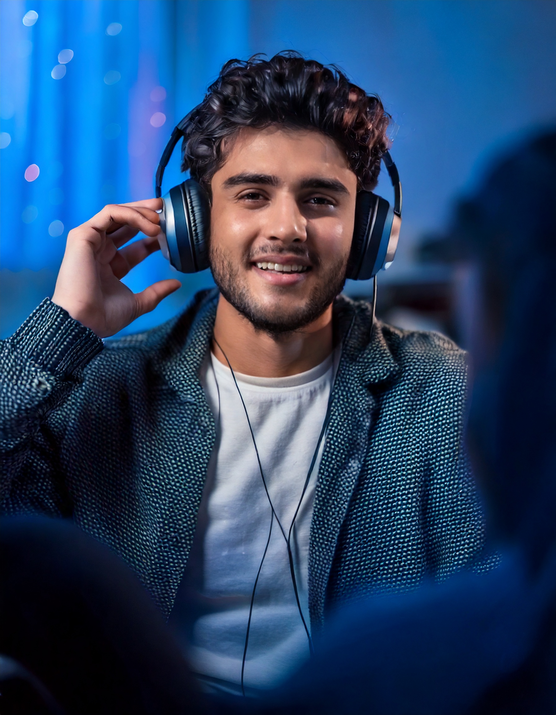 Firefly casual happy young adult with headphones; house indoor background; with a friend;