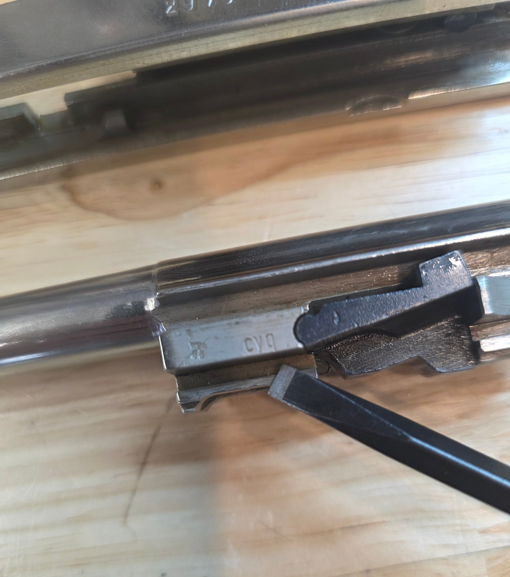 'cyg' on the barrel indicates this gun was made at Spreewerk. There is a makers stamp on the slide, the characters are visible but unreadable due to the chrome finish.