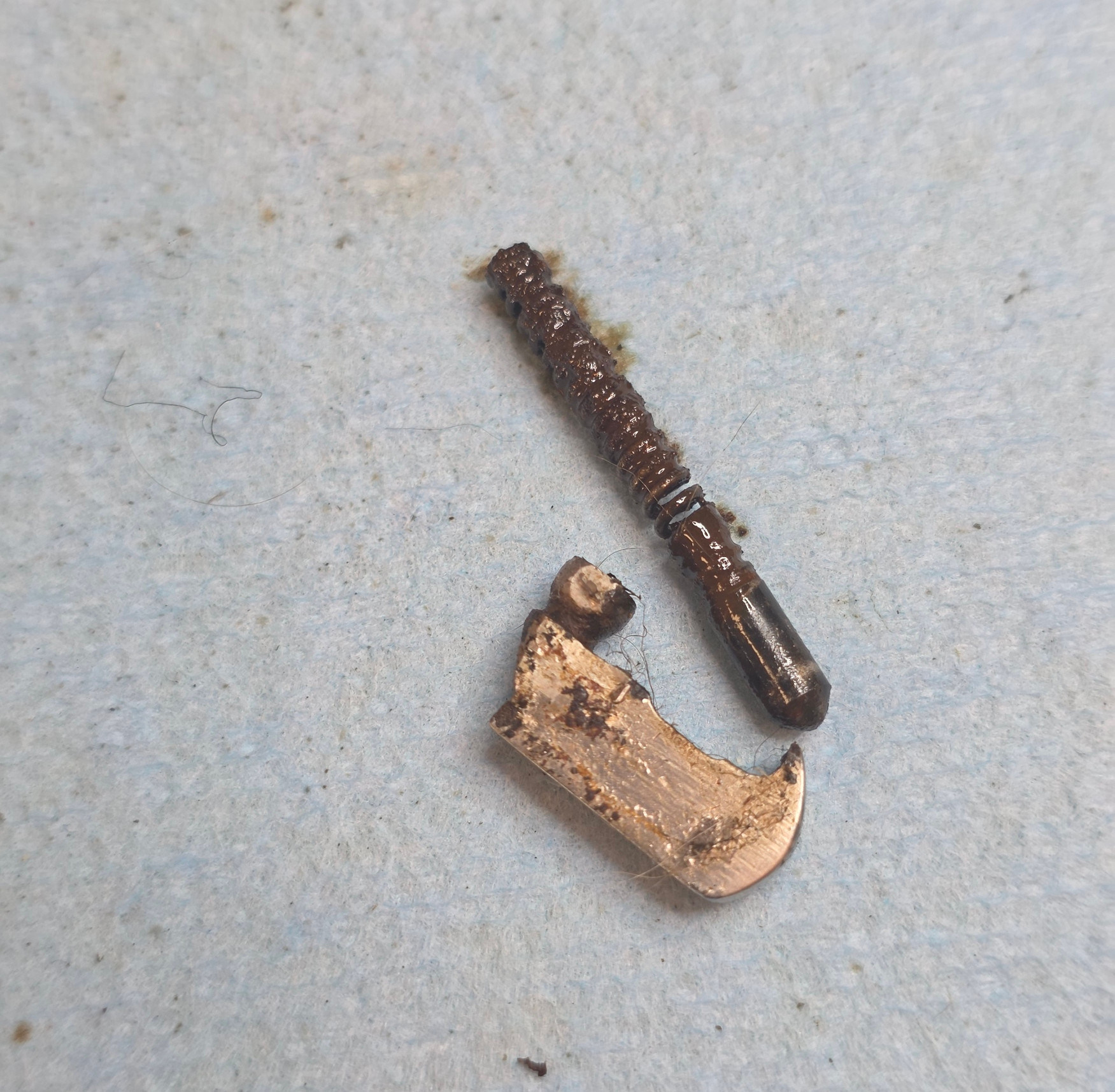 The extractor, plunger, and spring once they finally came free of the slide.