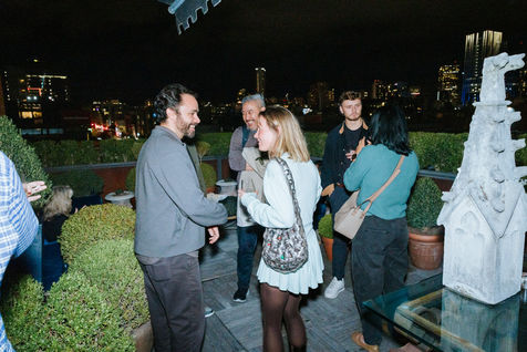 Business professionals networking and talking during a technology conference in the San Francisco Bay Area, discussing AI and