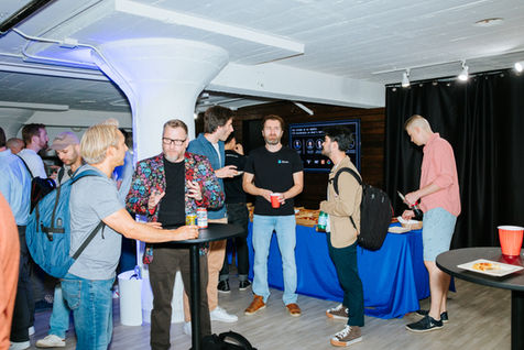 Group of people socializing at an indoor event.