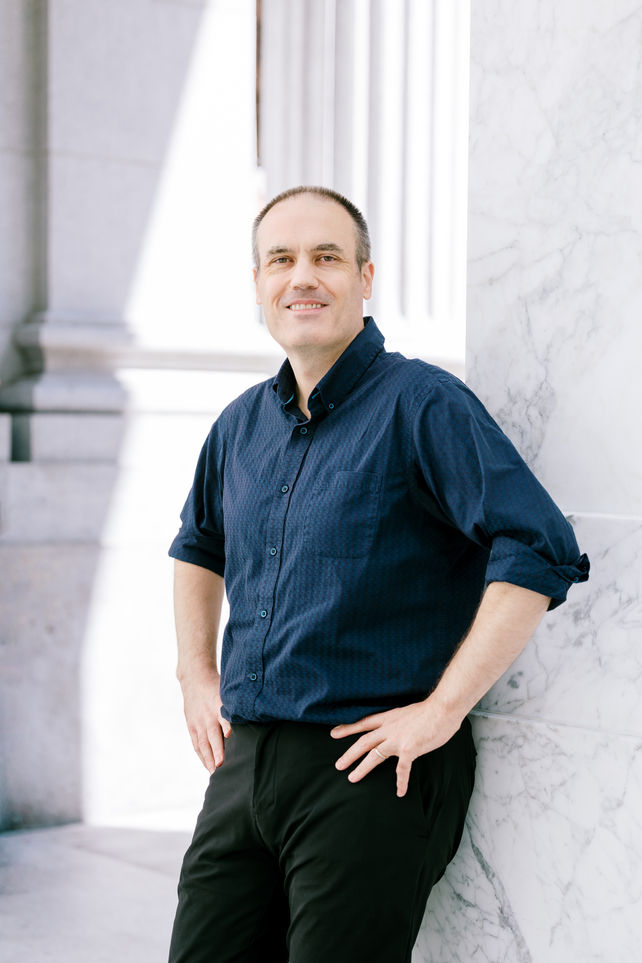 Professional executive headshot of a business professional in downtown San Francisco, photographed with natural light and a m
