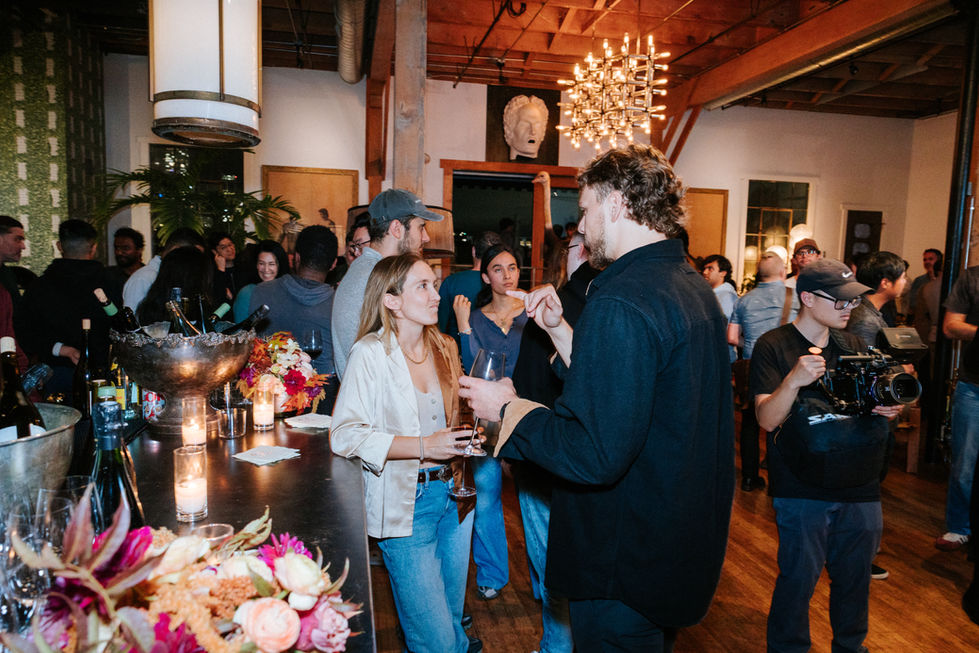 Professionals engaged in conversation at a corporate technology conference in the San Francisco Bay Area, highlighting networ