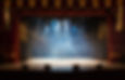 An empty stage of the theater, lit by sp