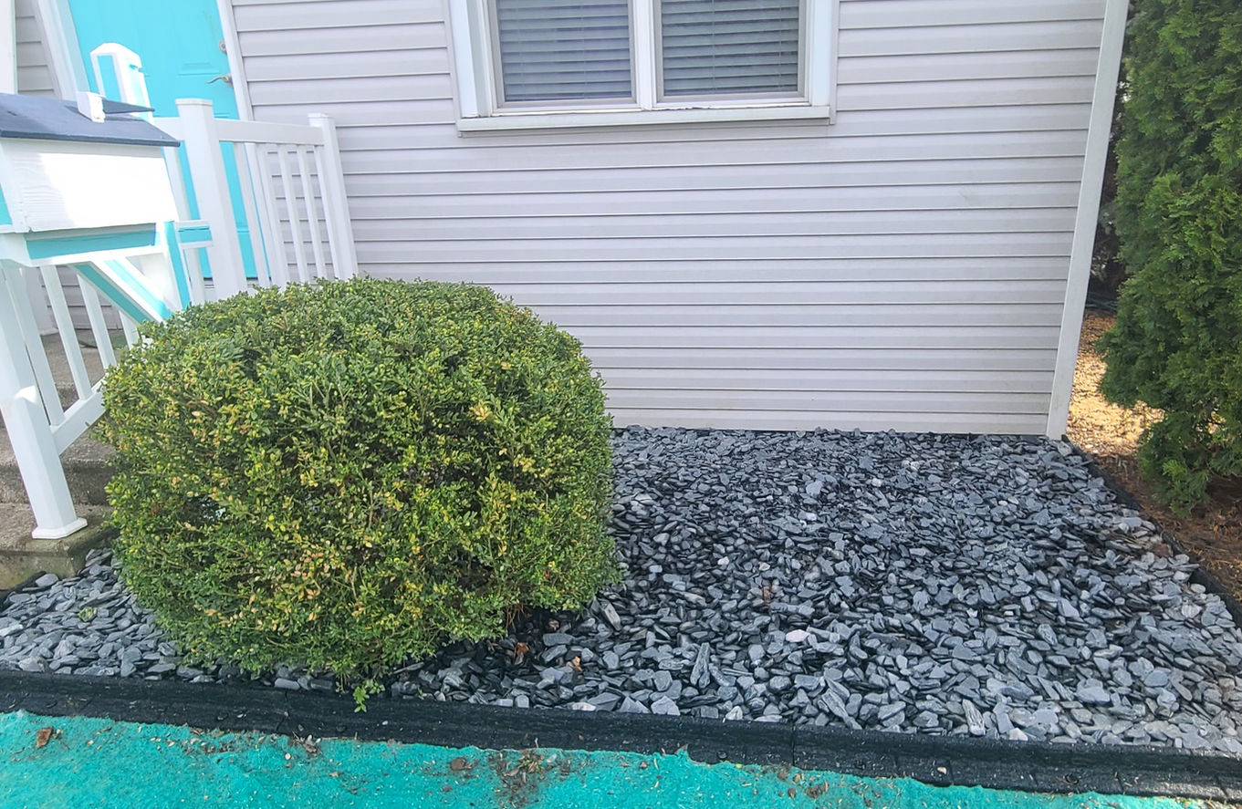Landscaping stone and shrub trimming