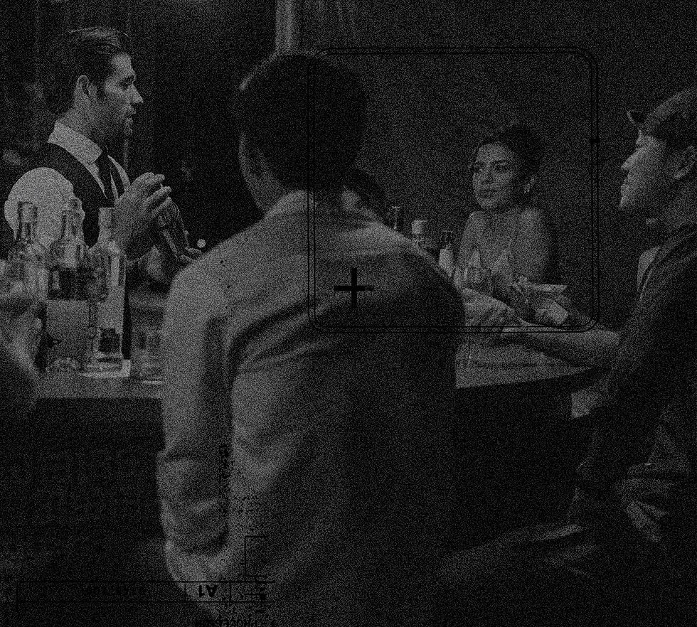 low-light image of three people collaborating over a table in a tech setting