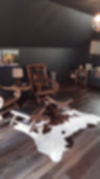High Color Variation Floating Vinyl Plank Flooring in Young Harris, Georgia with cow hide rug and moody decor. LVP, Luxury Vinyl Plank