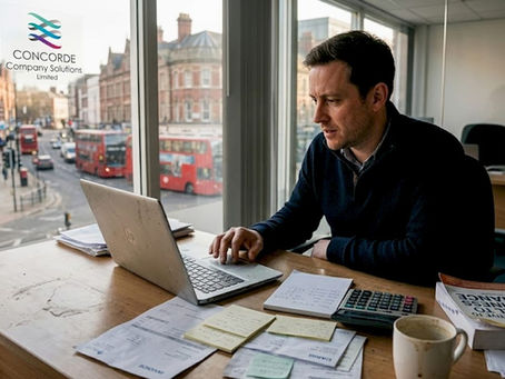 UK SME owner working at cluttered desk