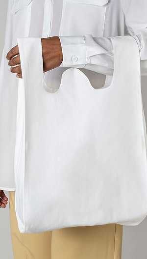 black-woman-carrying-white-reusable-grocery-bag.jpg