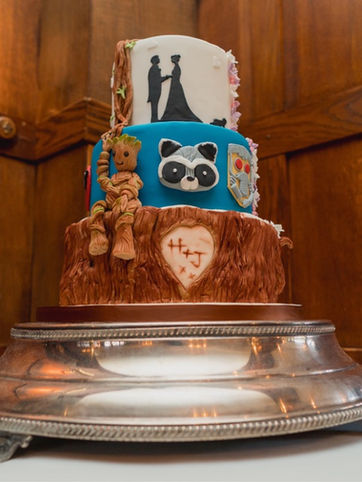 Unique animated wedding cake with tree slice marvel characters and life theme 