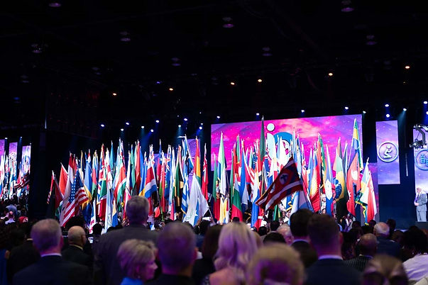 church with large tv screens projecting logo and church flags