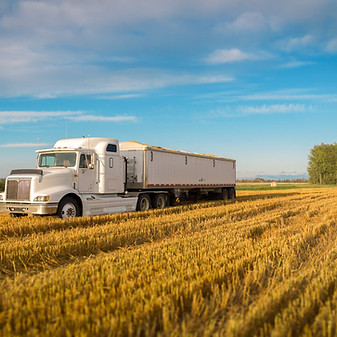 White Grain Truck on Freshly Harvested Field