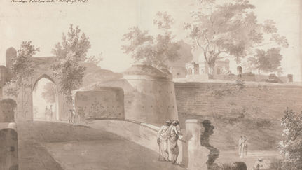 A brown wash pen and brown ink drawing shows a view of the Monghyr fort as if approaching from the bridge. The entrance of the bridge sits at the foreground of the drawing, and two men chat while leaning against the side of the bridge. A camel approaches from the other side of the bridge in the distance. In the top right, the fort can be seen amongst some trees. 