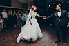 A beautiful bride in a long-detailed wedding dress about to dance with the groom. Howe Sounds provides DJ rentals for all types of weddings.