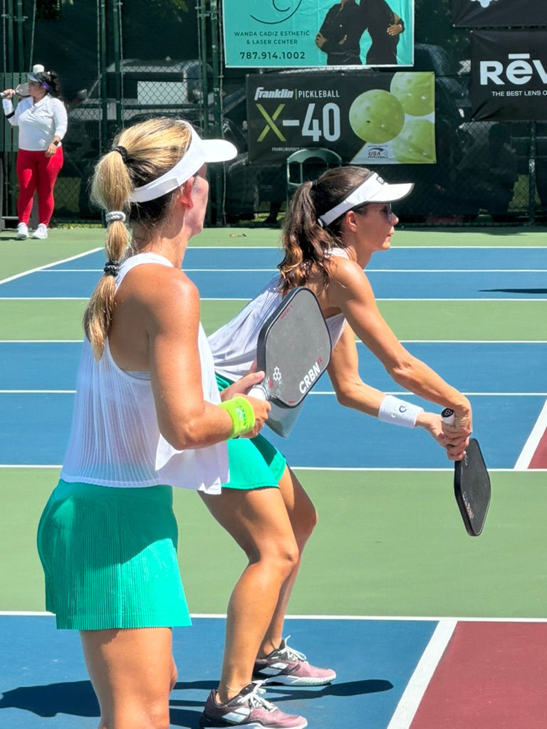 Two women playing pickleball