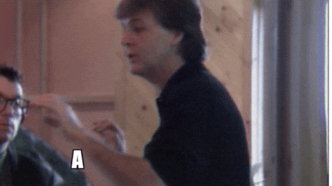 Man in a black shirt making hand gestures.