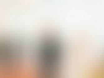 A happy newly wed couple in a canvas and pole wedding marquee enshrouded in giant confetti