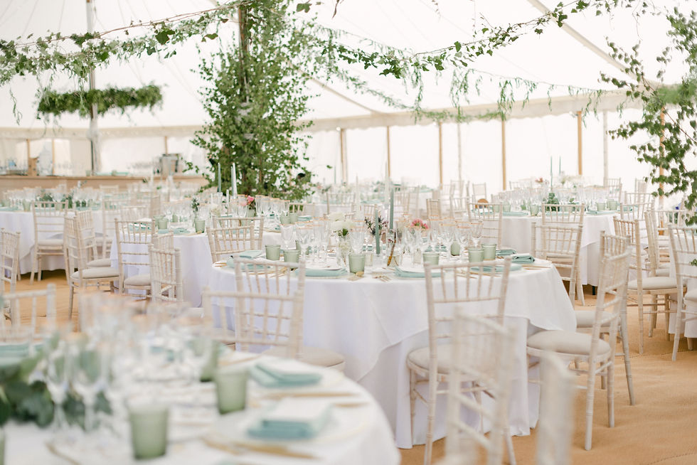 Large round tables inside a Peacock and Bow pole and canvas marquee.