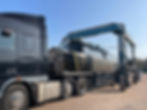 Gantry crane loading boat onto truck trailer