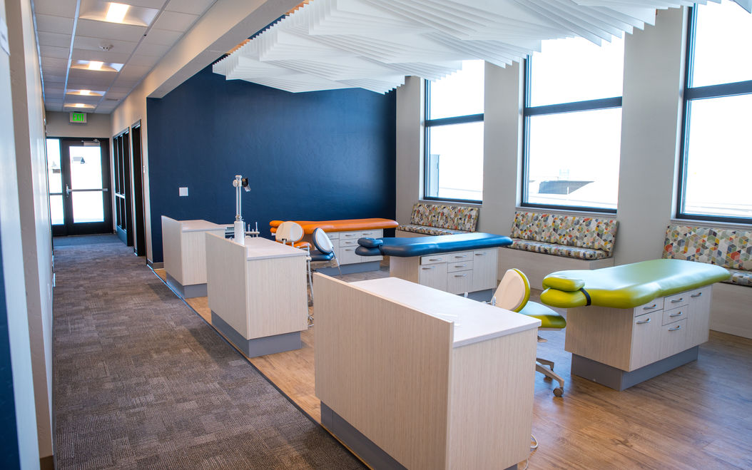 children's dentist office with rows of dentist chairs bright fun colors