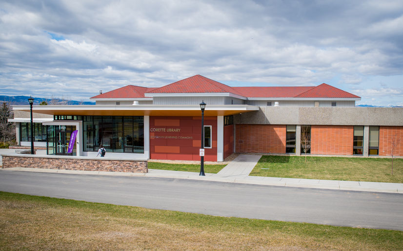 outside view of beautiful college library building with red walls and large windows