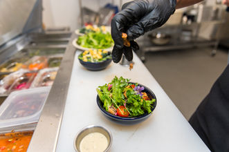 Mt Ascension Brewing house salad being skillfully prepared in the kitchen